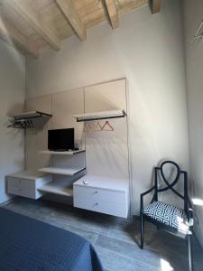 a bedroom with a bed and a dresser and a mirror at A casa di Linda in Tivoli