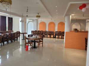 a large dining room with tables and chairs at Hotel Royal Vilas in Bharatpur