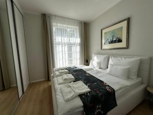 a bedroom with a bed with towels on it at Rezidencia OPERA - Villa Bizet in Turčianske Teplice