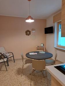 a living room with a table and chairs at Casa Coletta in Bosco Chiesanuova
