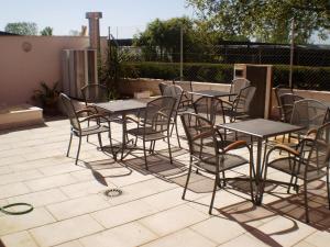 eine Gruppe von Tischen und Stühlen auf einer Terrasse in der Unterkunft Hostal Rica Posada in Guadalajara