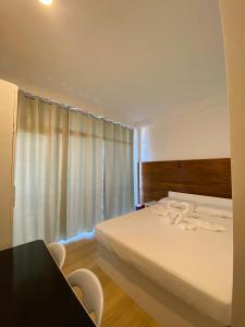 a bedroom with a bed and a table and chairs at Smith Inn & Restaurant in General Luna