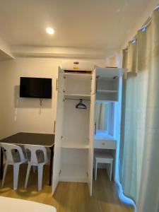 a small room with a table and a bunk bed at Smith Inn & Restaurant in General Luna