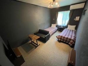 Postel nebo postele na pokoji v ubytování ペンションcollege白馬 + 5 fotografií