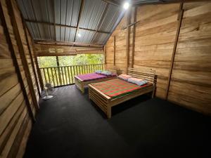 an inside view of a room with two beds at Eco Cabins Kitulgala in Kitulgala