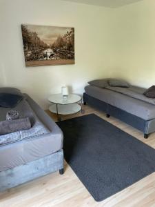 a room with two beds and a table at ZV-Scholtz Burghausen Mozartstr, 15 AP-KL in Burghausen