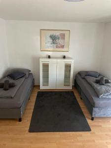 a living room with two beds and a table at ZV-Scholtz Burghausen Mozartstr, 15 AP-KL in Burghausen +34 photos