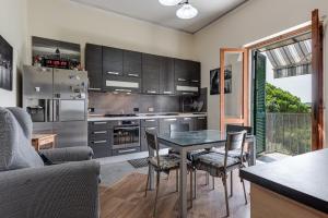 a kitchen with a table and chairs in a room at House of Flowers in Marti