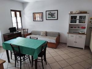 a living room with a table and a bed at Alloggio in valle maira in Macra