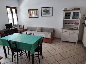 a living room with a table and a bed at Alloggio in valle maira in Macra