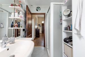 a bathroom with a white sink and a mirror at House of Flowers in Marti +14 photos