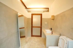 a bathroom with a toilet and a sink at KoLac Villa in Elagawagoda