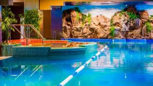 a swimming pool with a boat in the water at Deluxe Apartments & Studio With Many Facilities in Bucharest