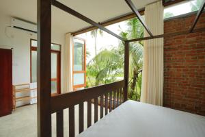 a room with a brick wall and a window at KoLac Villa in Elagawagoda