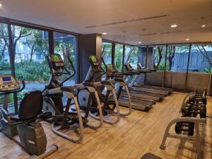 a gym with several treadmills and elliptical machines at The Deck Patong 7Fl Mountain View 1 in Patong Beach