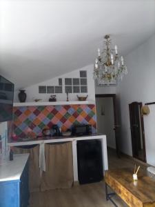 a kitchen with a table and a chandelier at La madrileña 2 in Casabermeja