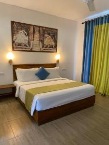 Postel nebo postele na pokoji v ubytování Hotel Sigiriyaaya