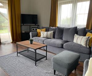 a living room with a couch and a coffee table at Kata Vendégház in Kapolcs