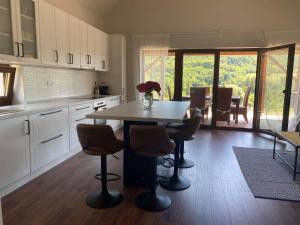 a kitchen with a table and chairs and a dining room at Kata Vendégház in Kapolcs