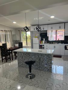 a kitchen with a island in the middle of a room at Bula house in Lautoka