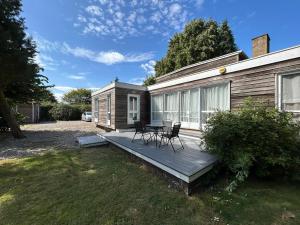 a patio with two chairs and a table on a house at Wood Place in Diss