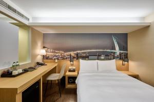 Voodi või voodid majutusasutuse Eastin Taipei Hotel toas