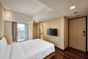 Voodi või voodid majutusasutuse Eastin Taipei Hotel toas