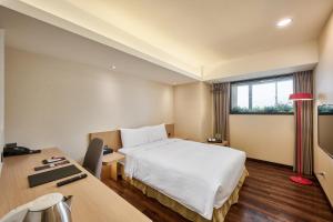 Voodi või voodid majutusasutuse Eastin Taipei Hotel toas
