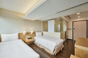 Voodi või voodid majutusasutuse Eastin Taipei Hotel toas