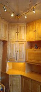 a kitchen with wooden cabinets and a yellow counter top at Vintage Apartment in Graz