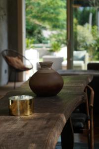 a vase sitting on top of a wooden table at La Bolla Verde Lake Como in Lecco +43 photos