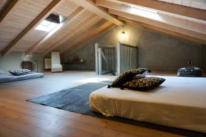 a large room with two beds in a attic at La Bolla Verde Lake Como in Lecco