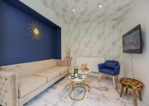 a living room with a couch and a blue wall at Le Cosy - Appartement avec Jardin Wimille proche Wimereux in Wimereux