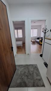 a room with a door leading to a living room at Stan Banjaluka Srara Ada 1 in Rebrovac +4 photos