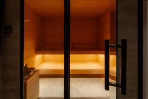 a sauna is shown through a glass door at Apartamentos 2H LIVING in León