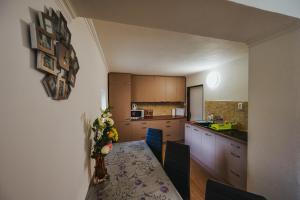 a kitchen with a table and a dining room at Chata Maxim Bojnice in Bojnice