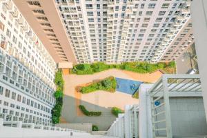 a building with a wall with plants on it at Comfort and Nice 2BR at Tokyo Riverside PIK 2 Apartment By Travelio in Rawalembang