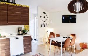 a kitchen and dining room with a white table and chairs at 3 Bedroom Gorgeous Home In Löttorp in Löttorp