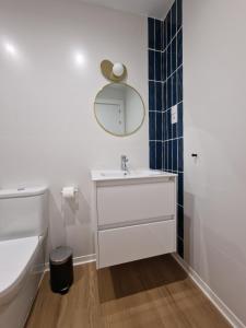 a white bathroom with a sink and a mirror at El 34 1º in Lorca