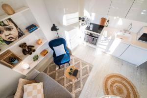 an overhead view of a living room with a blue chair at Central Lux Condo In Downtown in Helsinki