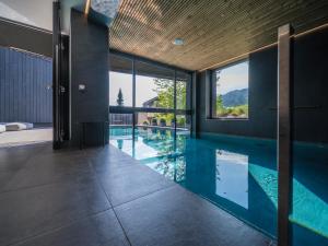 an infinity pool in a house with a view at Black Summit Boutique Resort Laax in Laax