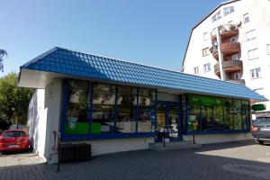 a building with a blue roof on a street at Art Apart in Płock