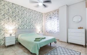 a bedroom with a bed and two night stands at Stunning Apartment In Fuengirola in Fuengirola