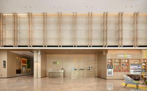 a lobby of a shopping mall with a large glass wall at Home2 by Suite Liaocheng Dongchang in Liaocheng