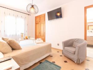 a bedroom with a bed and a desk and a chair at 274 Villa Manresa ETV 4301 by Mallorca Charme in Alcudia