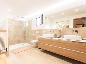 a bathroom with two sinks and a shower and a toilet at 274 Villa Manresa ETV 4301 by Mallorca Charme in Alcudia +31 photos