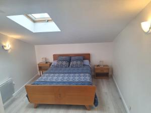 a bedroom with a bed and a skylight at Chez Loulou du Linas - Bugarach in Bugarach