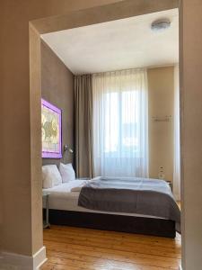 Un dormitorio con una cama grande y una ventana. en Augusta Trarbach, en Traben-Trarbach