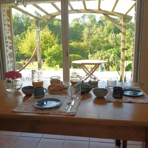a table with plates of food on top of it at Chambre des bords de Siame in Gratot +4 photos