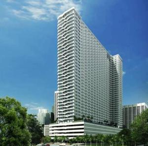 a tall building with many windows in a city at Luxurious Bayview 2BR Near MOA PICC CCP Free WiFi in Pasay in Manila